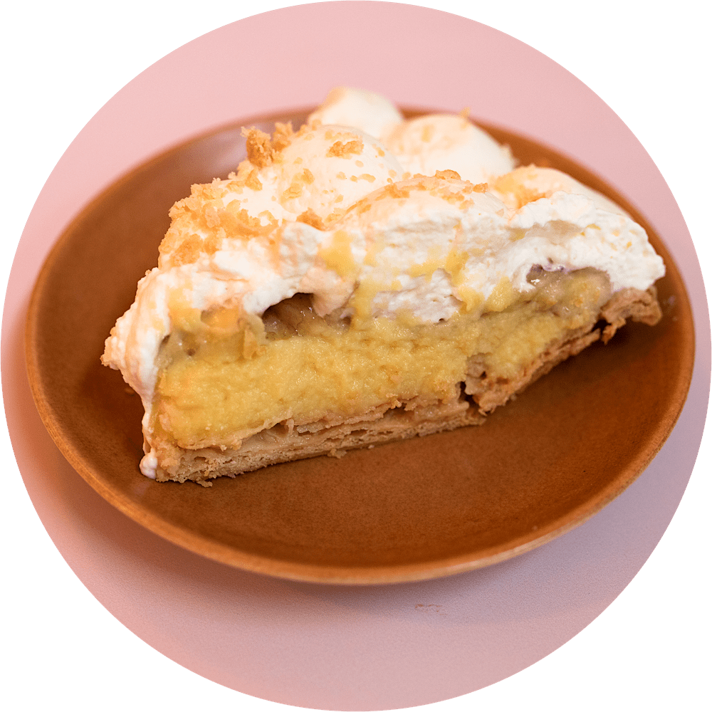 Banana cream pie slice with fresh banana filling and fluffy whipped cream from Petee's Pie Company NYC