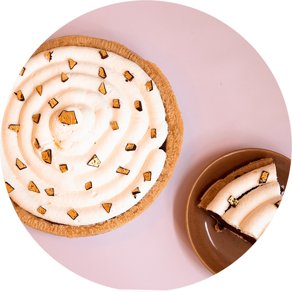 Lavish chocolate cream pie with gold leaf chocolate flakes and whipped cream from Petee's NYC bakery