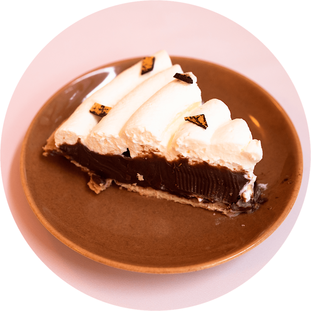 Chocolate cream pie slice with bittersweet chocolate filling and gold leaf flakes at Petee's NYC