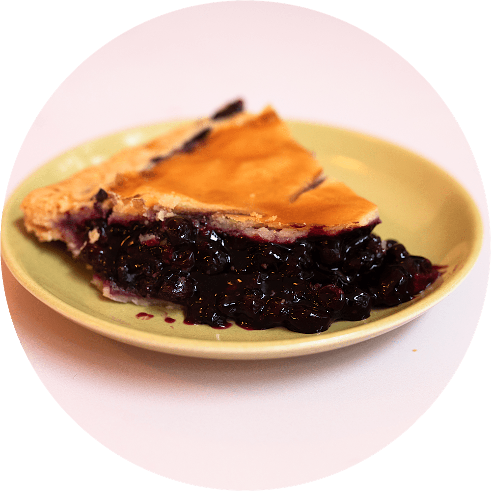 Wild Maine blueberry pie slice with juicy blueberries and golden pastry crust from Petee's Pie Company NYC