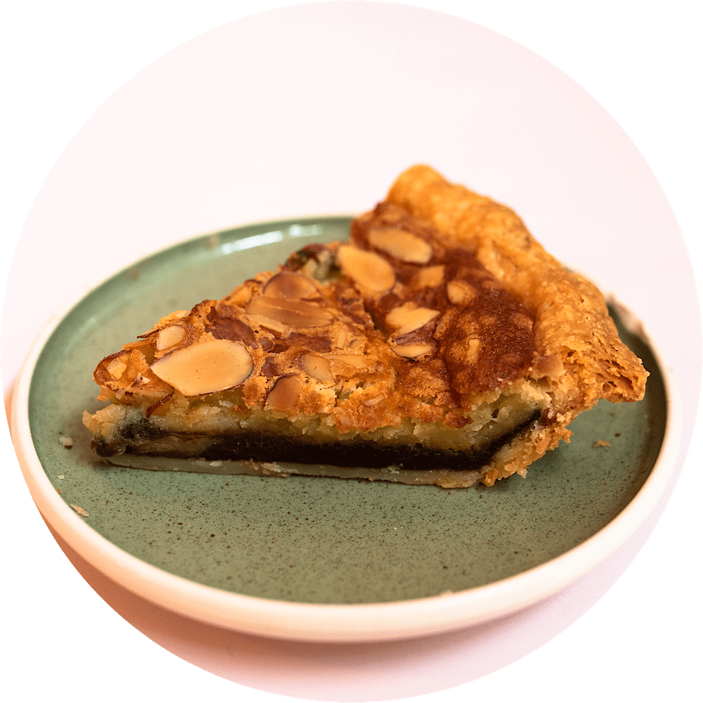 Black bottom almond chess pie slice with dark chocolate layer and rich buttermilk chess filling from Petee's Pie NYC