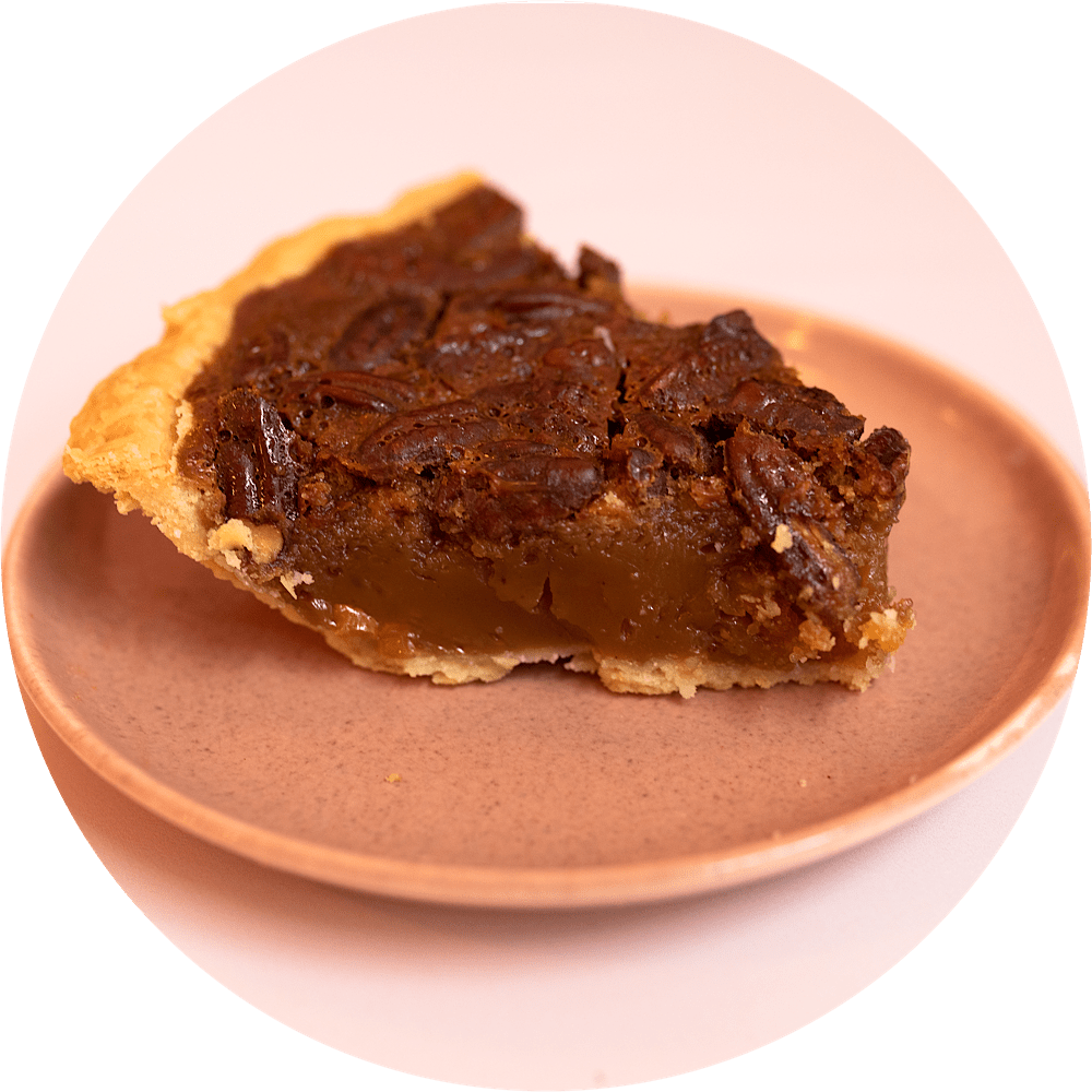 Brown butter honey pecan pie slice with golden filling and toasted pecans from Petee's Pie Company NYC