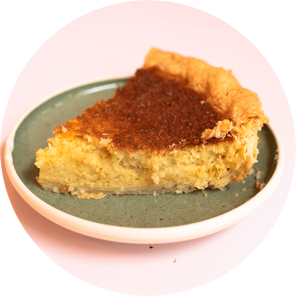 Coconut custard pie slice with silky custard filling and golden toasted coconut from Petee's Pie Company NYC