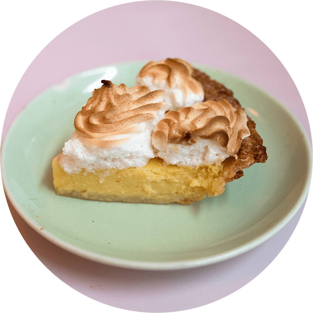 Key lime meringue pie slice with creamy key lime curd and golden meringue from Petee's Pie Company NYC