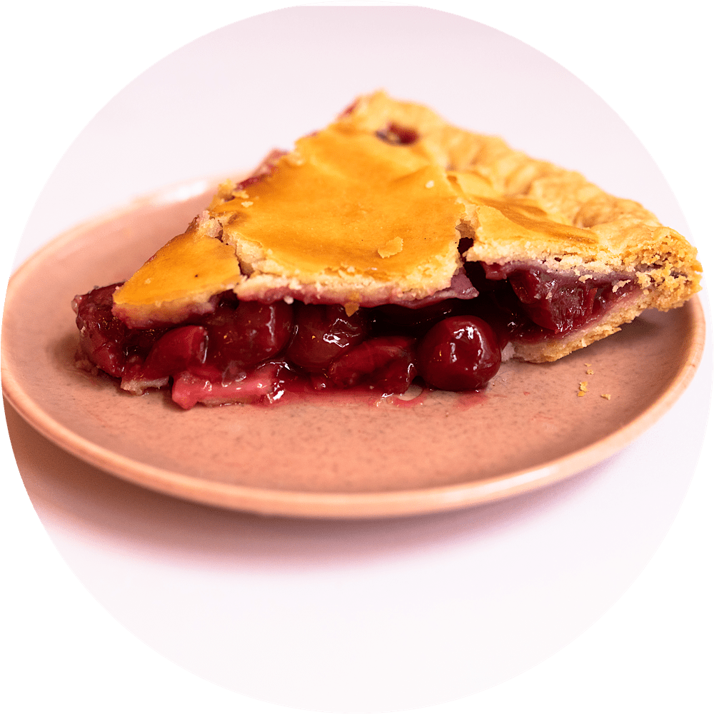 Sour cherry pie slice with ruby red filling and flaky pastry crust from Petee's Pie Company NYC